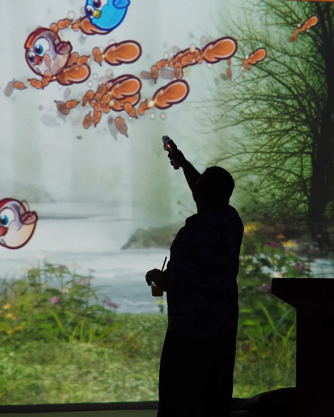 Visitor aiming at a projected game inside Target Zero
