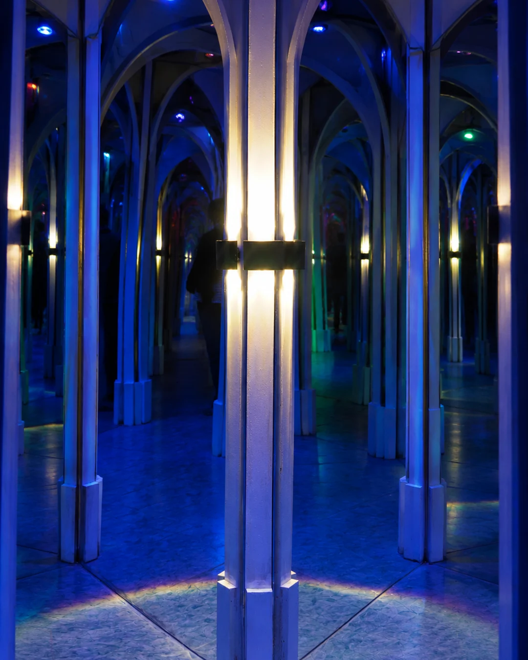 Mirrored arches and reflections inside The Maze