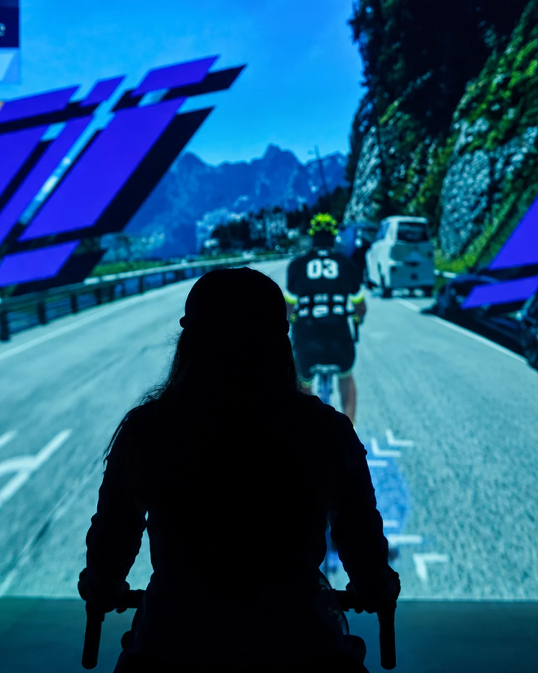 Visitor riding an exercise bike through a virtual world in The Trip